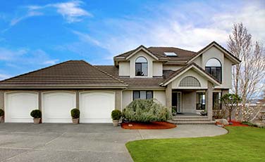 Three-simple-white-residential-garage-doors-installed-by-contractor