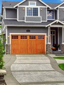 two car faux wooden garage door attached to a residential home