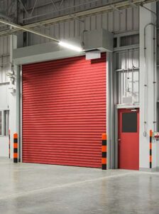 all red rolling commercial garage door inside an industrial warehouse
